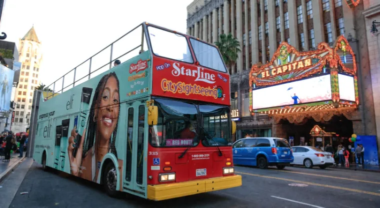Starline Tours double-decker on Hollywood Boulevard carrying a full-wrap campaign